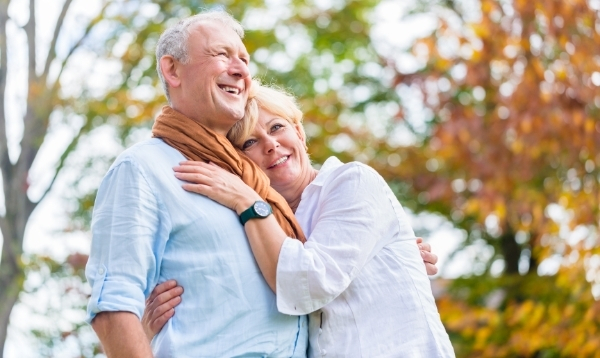 senior couple hugging outdoors in autumn